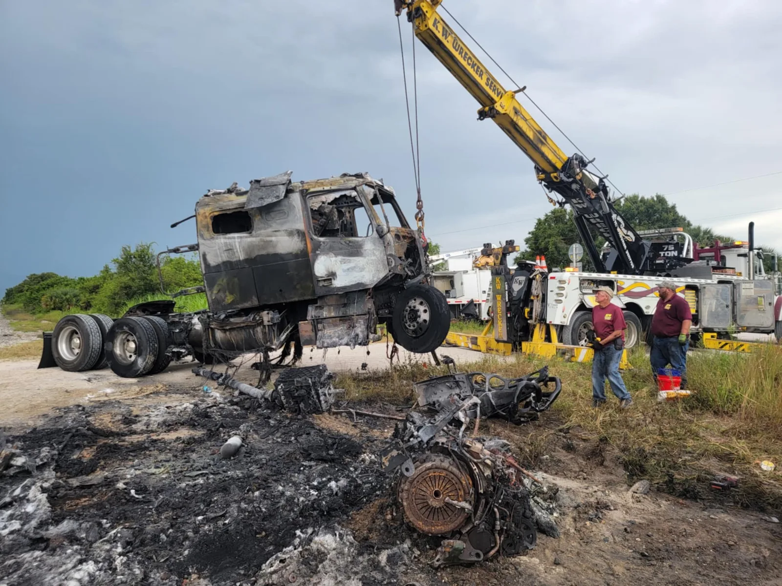 KW Wrecker Service 75-ton rotator recovering a burned semi-truck cab