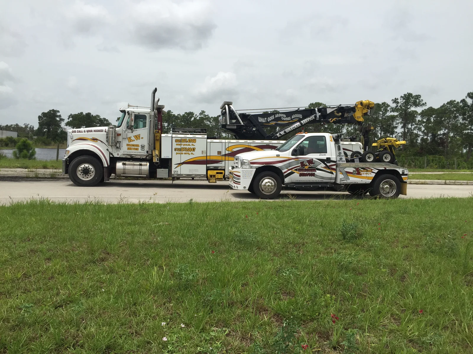 KW Wrecker Service fleet featuring a heavy-duty rotator alongside a light-duty wrecker